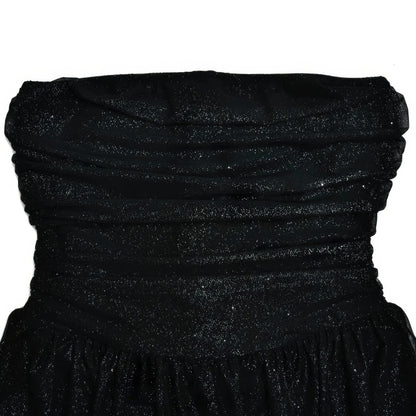 A black strapless dress with a sparkly, glittery texture.