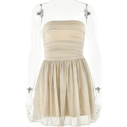 A strapless, beige dress with a ruched bodice and a full, pleated skirt.
